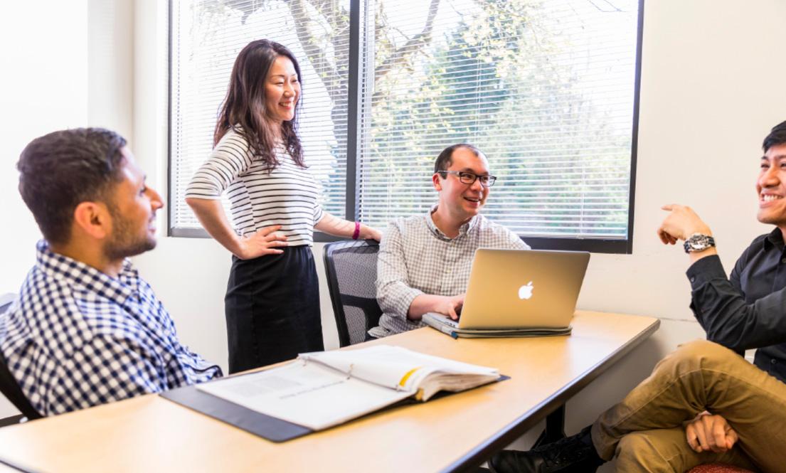 A few people collaborating at a table on a project